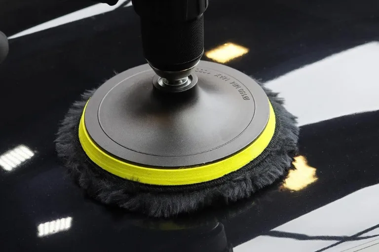 Professional detailer selecting foam, microfiber and wool polishing pads for automotive paint correction